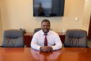 Photo of attorney Rashad A. Green sitting at a conference room